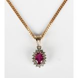 A 9ct gold, ruby and diamond oval cluster pendant, length 1.6cm, with a 9ct gold faceted curblink