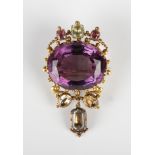 A Victorian gold, amethyst and foil backed varicoloured gem set brooch, claw set with the oval cut