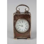 An Edwardian silver cased diminutive carriage timepiece with scroll carry handle, on bun feet,