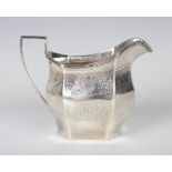 A George III silver octagonal cream jug with reeded rim above a band engraved with a fruit and