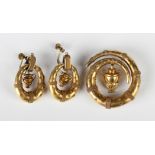 A Victorian gold brooch of coiled form with applied bead and wirework decoration, the centre with