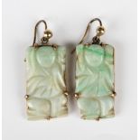 A pair of Chinese gold mounted rectangular jade pendant earrings, each carved as a figure, with wire
