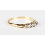 A gold and diamond five stone ring, the mount decorated with scrolled sides, detailed '18ct', weight