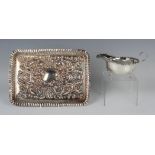 An Edwardian silver rectangular dressing table tray, embossed with foliate scrolls, flowers and