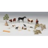 A small collection of Britains farm series lead figures and accessories, including two cows, a