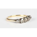 A gold and diamond five stone ring, collet set with a row of cushion cut diamonds graduating in size