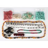 A quantity of necklaces and loose beads, including coral, shell and glass beads.Buyer’s Premium 29.