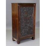 An early 20th century mahogany side cupboard, the door inset with a Chinese carved panel of two