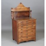 An early 19th century mahogany collector's chest, the raised shelf back above seven graduated