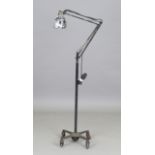 An early 20th century anglepoise lamp standard by Herbert Terry, black painted and fitted with a