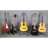 A group of five guitars, comprising an Infinity semi-acoustic, an Eko acoustic, two other acoustic