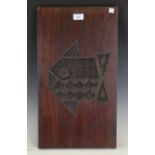 A set of four mid-20th century teak rectangular panels, each with a stylized carved motif,