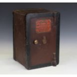 An early 20th century cast iron 'Perry's Fire Resisting Safe', fitted with a hinged door and