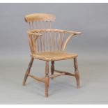 A 19th century ash and elm primitive stick and bar back Windsor armchair, height 83cm, width 55cm.