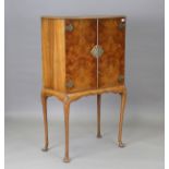 A mid-20th century Queen Anne style walnut drinks cabinet with fitted interior, enclosed by two