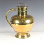 A 19th century brass flagon with circular lid, shaped handle and flared foot, height 39cm.Buyer’s