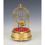 A modern gilt brass automaton musical birdcage and bird, height 27cm, diameter 16cm.Buyer’s