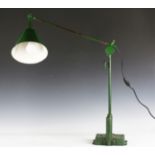 A mid-20th century Industrial green painted metal workshop lamp with anglepoise stem and conical