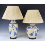 A matched pair of modern yellow glazed porcelain table lamps with cream pleated silk shades, heights