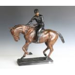 A modern cast bronze equestrian figure of a jockey on horseback, raised on a naturalistic base,