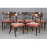 A set of six Regency mahogany bar back dining chairs with later tapestry seats, on reeded sabre