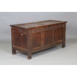 An early 18th century oak panelled coffer with wire hinges and carved frieze, height 65cm, width