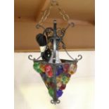 A mid-20th century wrought iron and coloured glass hanging lantern by Peter Marsh, height 35cm.