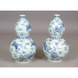 A pair of modern Chinese blue and white porcelain vases of double gourd form, height 60cm.Buyer’s