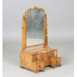 An early 20th century Queen Anne style walnut dressing table mirror, the base with an arrangement of