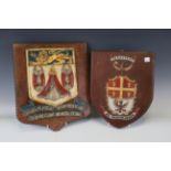 A group of five 19th and 20th century crest plates, including a carved oak example with bird and