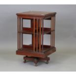 An Edwardian mahogany revolving bookcase, probably by Maple & Co, the iron framed base fitted with