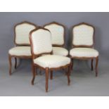 A set of four early 20th century French walnut showframe dining chairs, the backs and seats