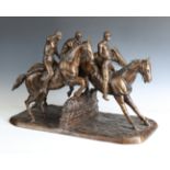 A large modern cast bronze equestrian figure group of three jockeys and their mounts jumping a