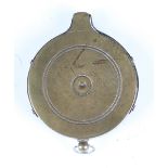 A 19th century steel mounted brass percussion cap dispenser of circular form with suspension loop,