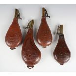 A group of four late 19th century leather shot flasks with embossed decoration, including one of