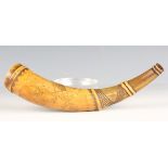 An early 19th century cow horn powder flask with carved and engraved decoration, detailed with a