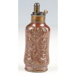 A fine, rare 19th century three-way pistol powder flask with shaped foliate embossed copper body and