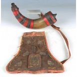 A Middle Eastern powder horn with painted red bands and alternating white metal geometric inlay,