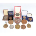 A large collection of mostly bronze European commemorative medallions, the majority 19th and 20th