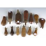 A collection of mid to late 19th century copper and brass powder flasks, mainly pistol, length of