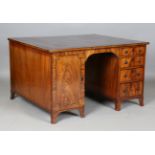 A Regency mahogany twin pedestal partners desk with ebony stringing, the top inset with gilt-