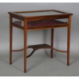 An Edwardian mahogany bijouterie table with bevelled glass top and boxwood stringing, height 71.5cm,