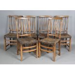 A set of six 20th century oak spindle back dining chairs with brass studded leather seats, height