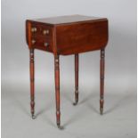 A Regency mahogany work table, fitted with two fall flaps and drawers, on ring turned legs and