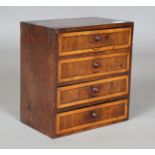 A 19th century provincial laburnum and fruitwood crossbanded table-top chest of four drawers, height