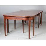 A late George III mahogany 'D' end dining table with central drop-leaf section, on block legs,