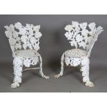A pair of Victorian cast iron garden chairs, probably by Charles D. Young & Co of Edinburgh, heavily