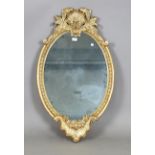 A modern rococo style gilt framed oval wall mirror, 102cm x 60cm.Buyer’s Premium 29.4% (including