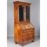 A Queen Anne walnut bureau bookcase with overall feather and crossbanded borders, the glazed top