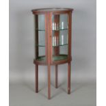 An Edwardian mahogany oval display cabinet with boxwood stringing, height 125cm, width 64cm, depth